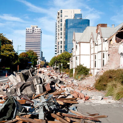The impact of global catastrophic events on reinsurance - building rubble piled on the side of the road